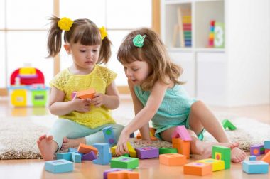 Kids are playing with montessori toys in kindergarten